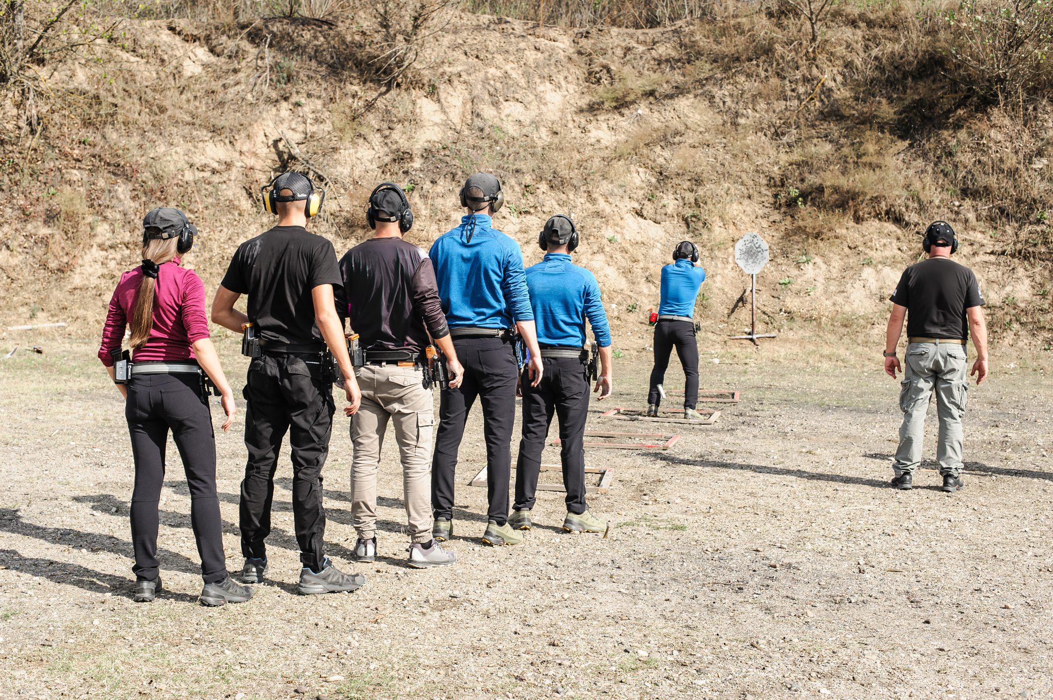 People practicing shooting at outdoor range.