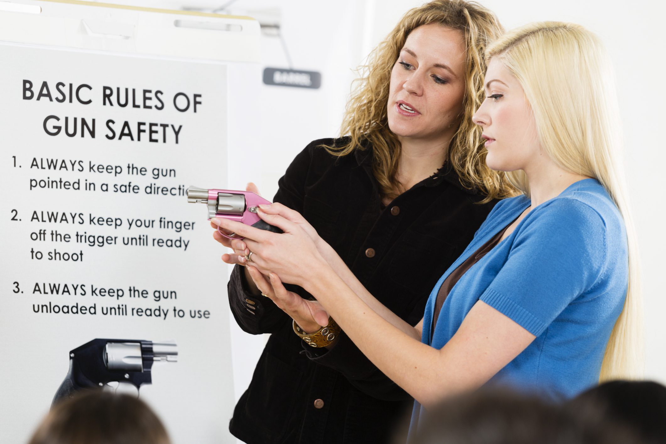 Two women discussing gun safety rules.